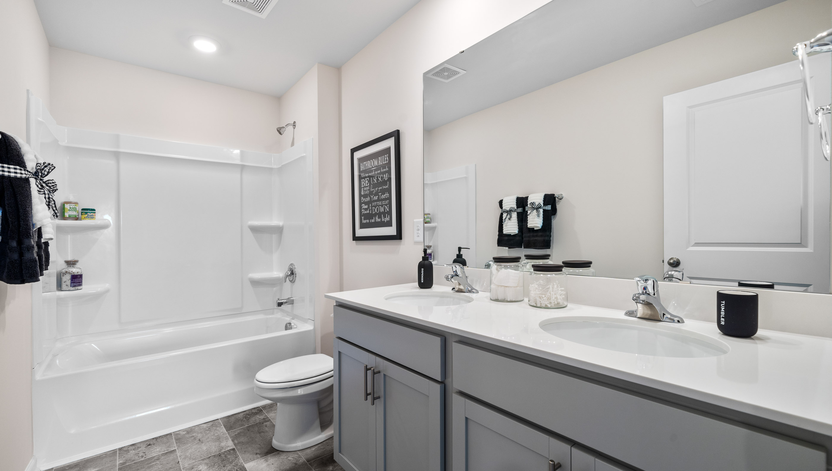 Double sink vanity with tub.