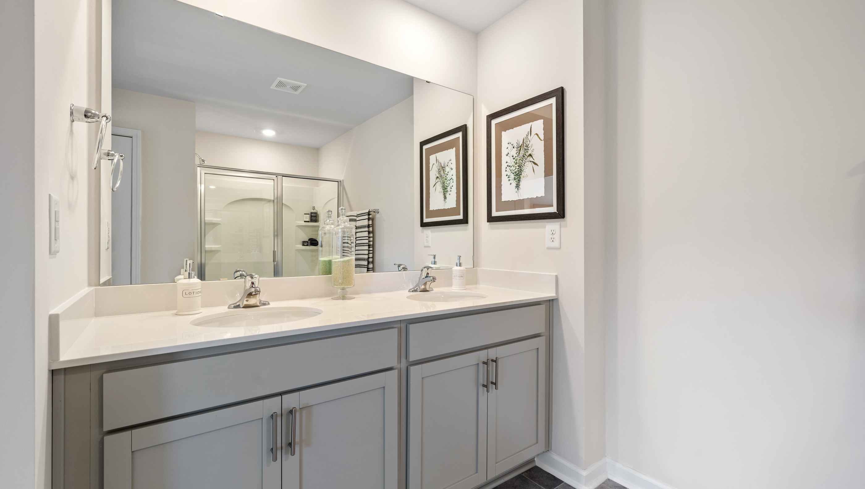 Double sink vanity of primary room.