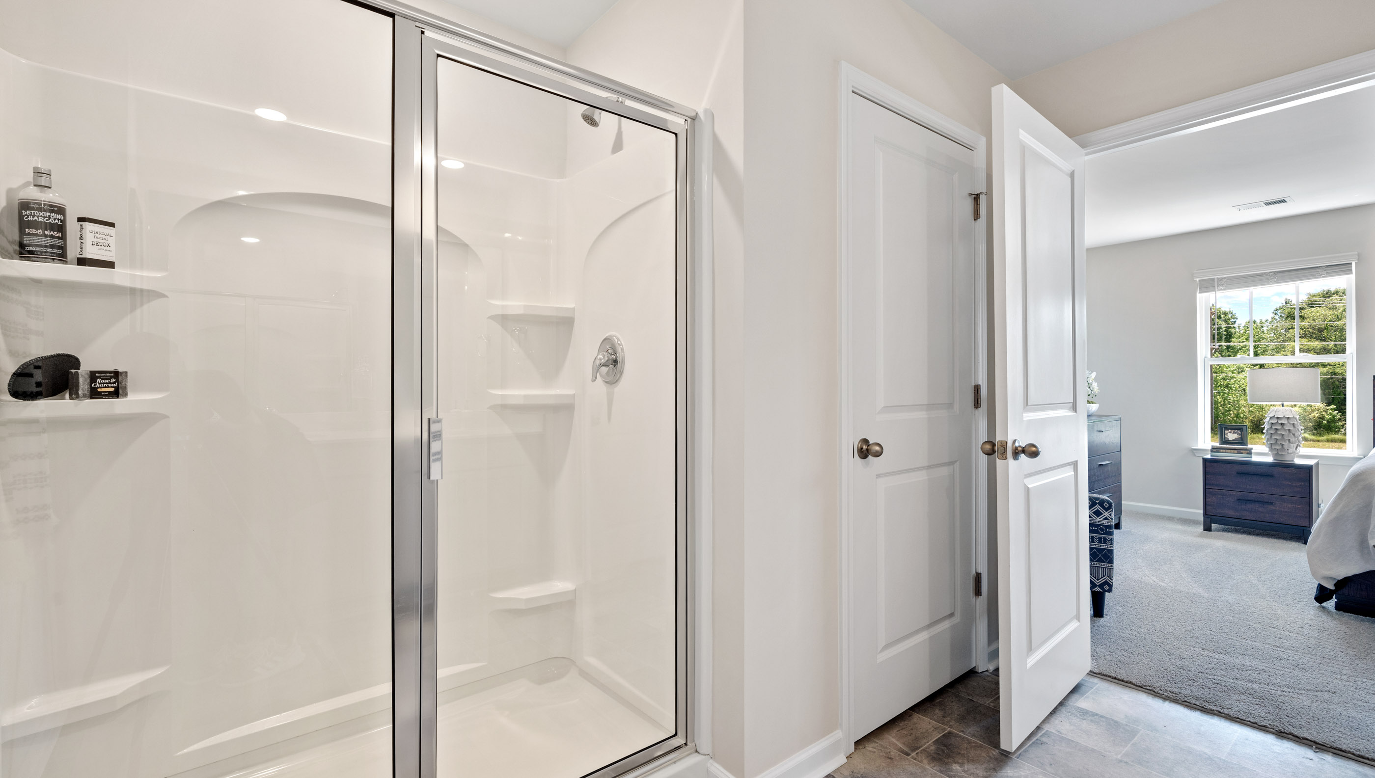 Walk in shower of primary bedroom.