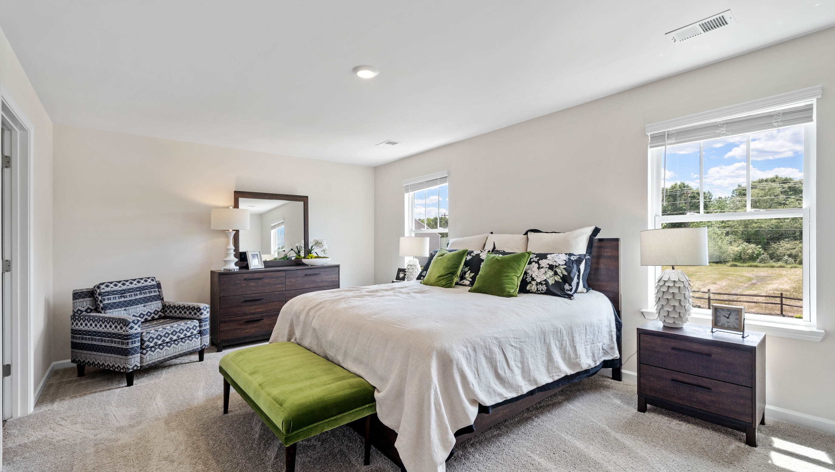 Primary bedroom with large windows.
