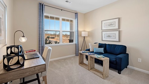 Bedroom with carpet and window.