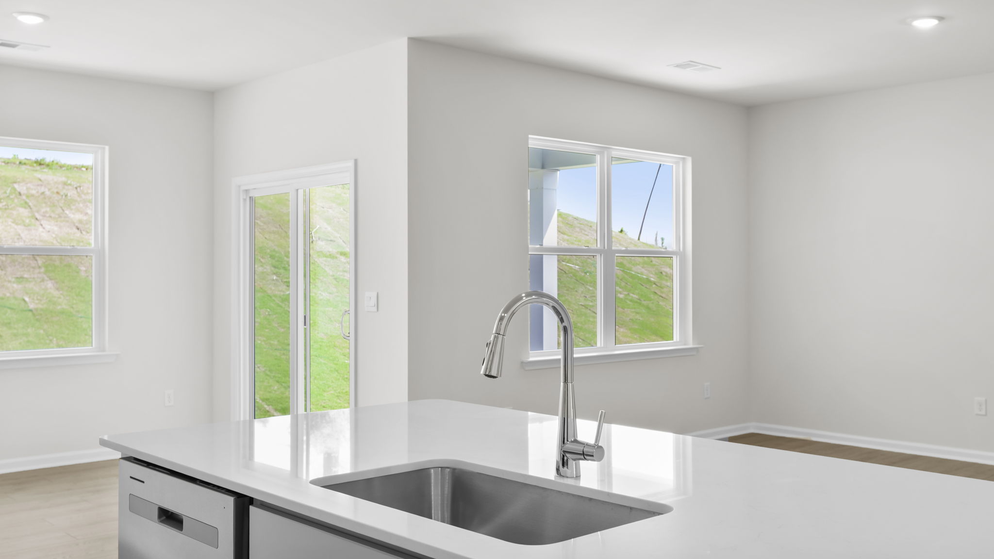Kitchen with quartz countertops and stainless steel appliances.