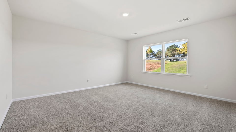 Bedroom with carpet and window.