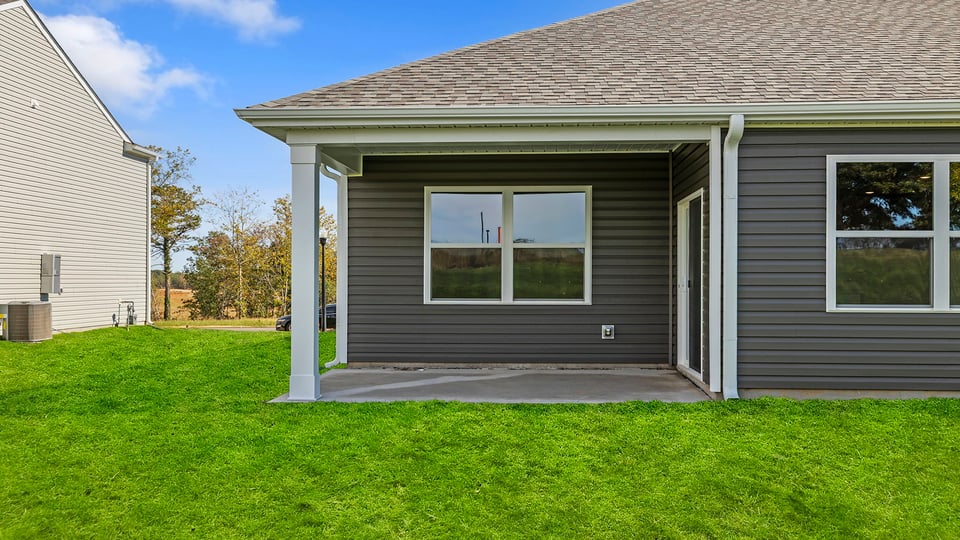 Back exterior of home with large backyard.