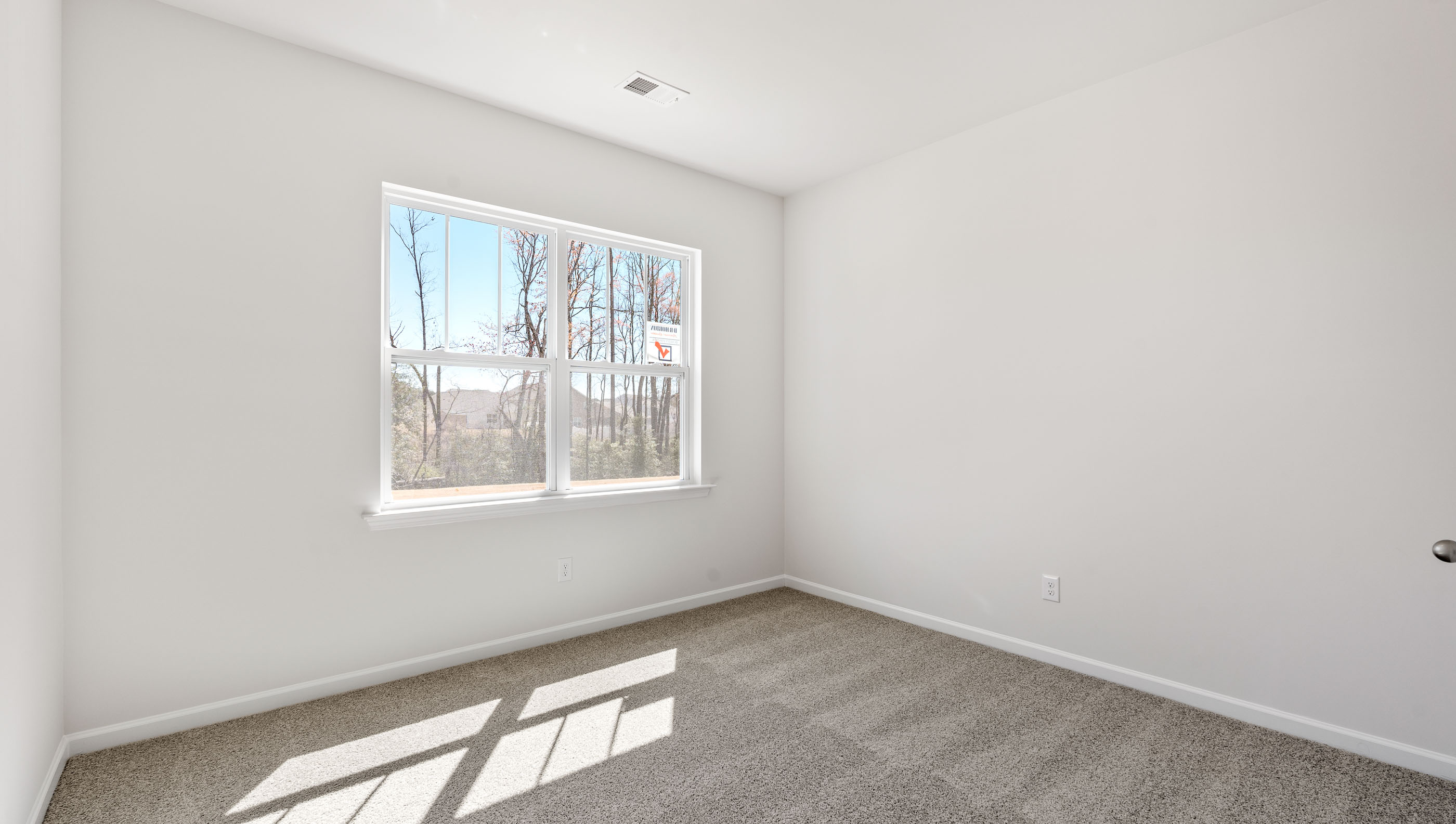 Bedroom with carpet and windows.