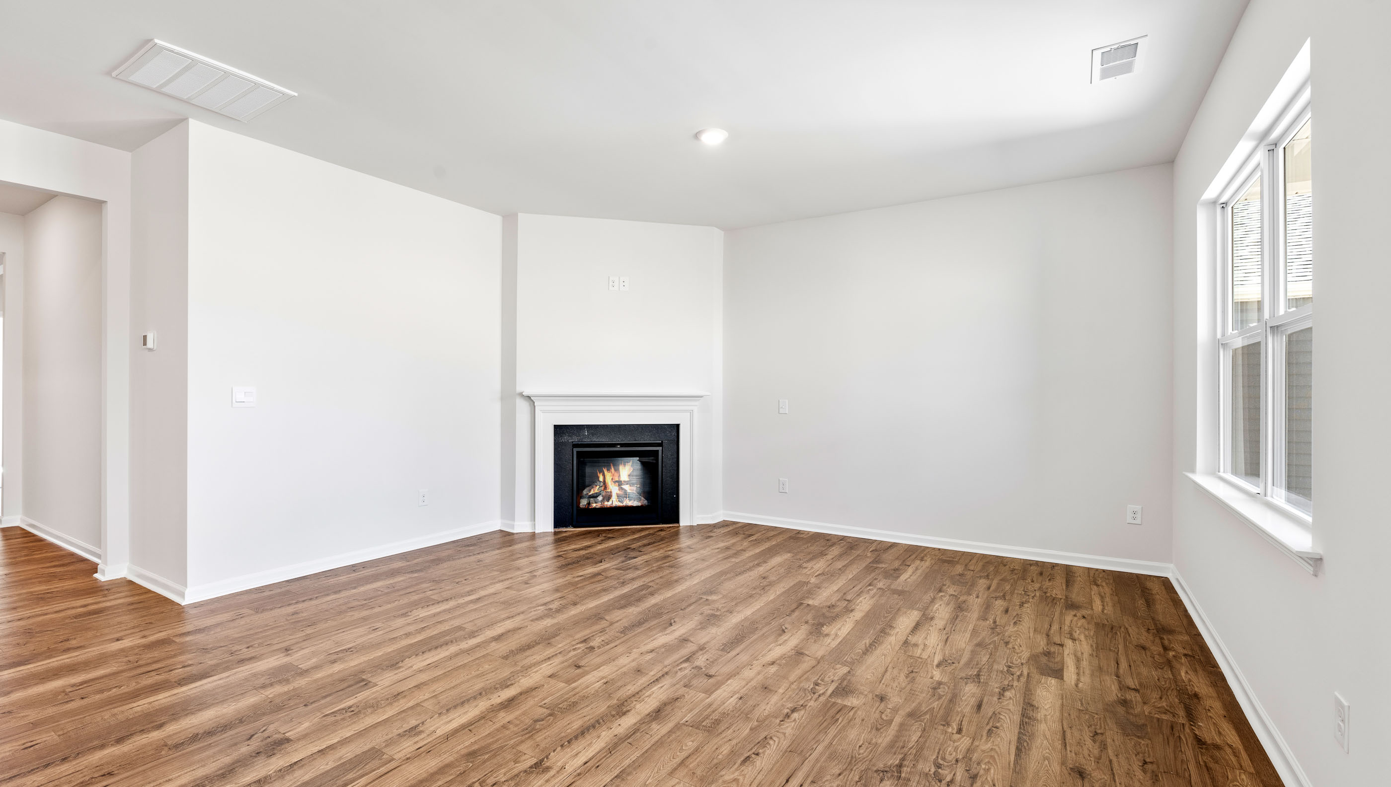 Living area with fireplace and windows.