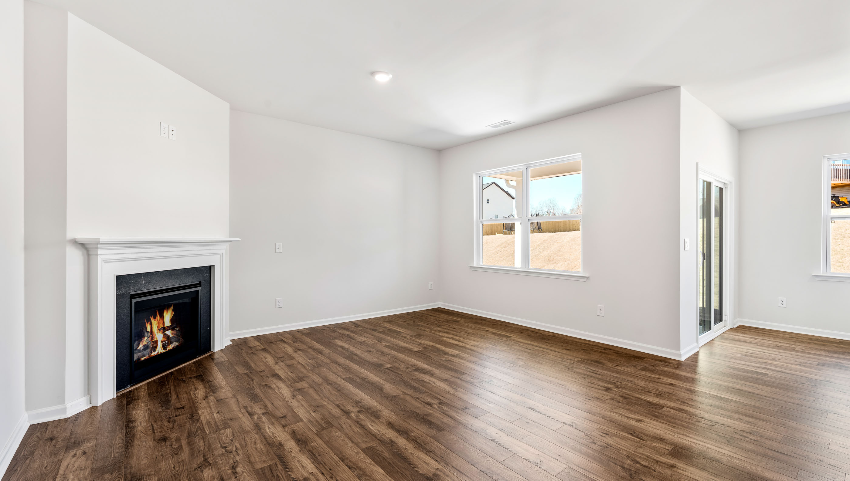 Living area with fireplace and windows.