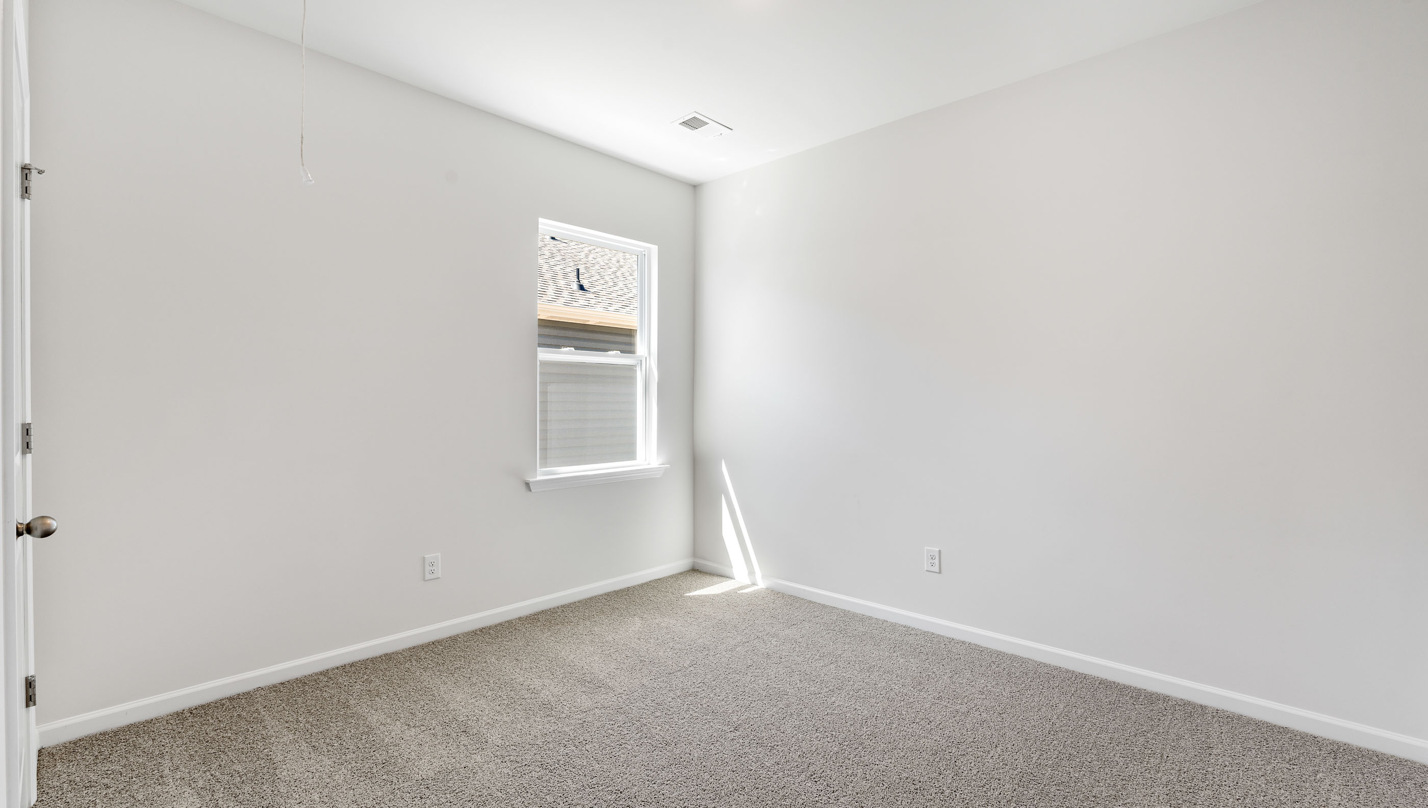 Bedroom with carpet and windows.