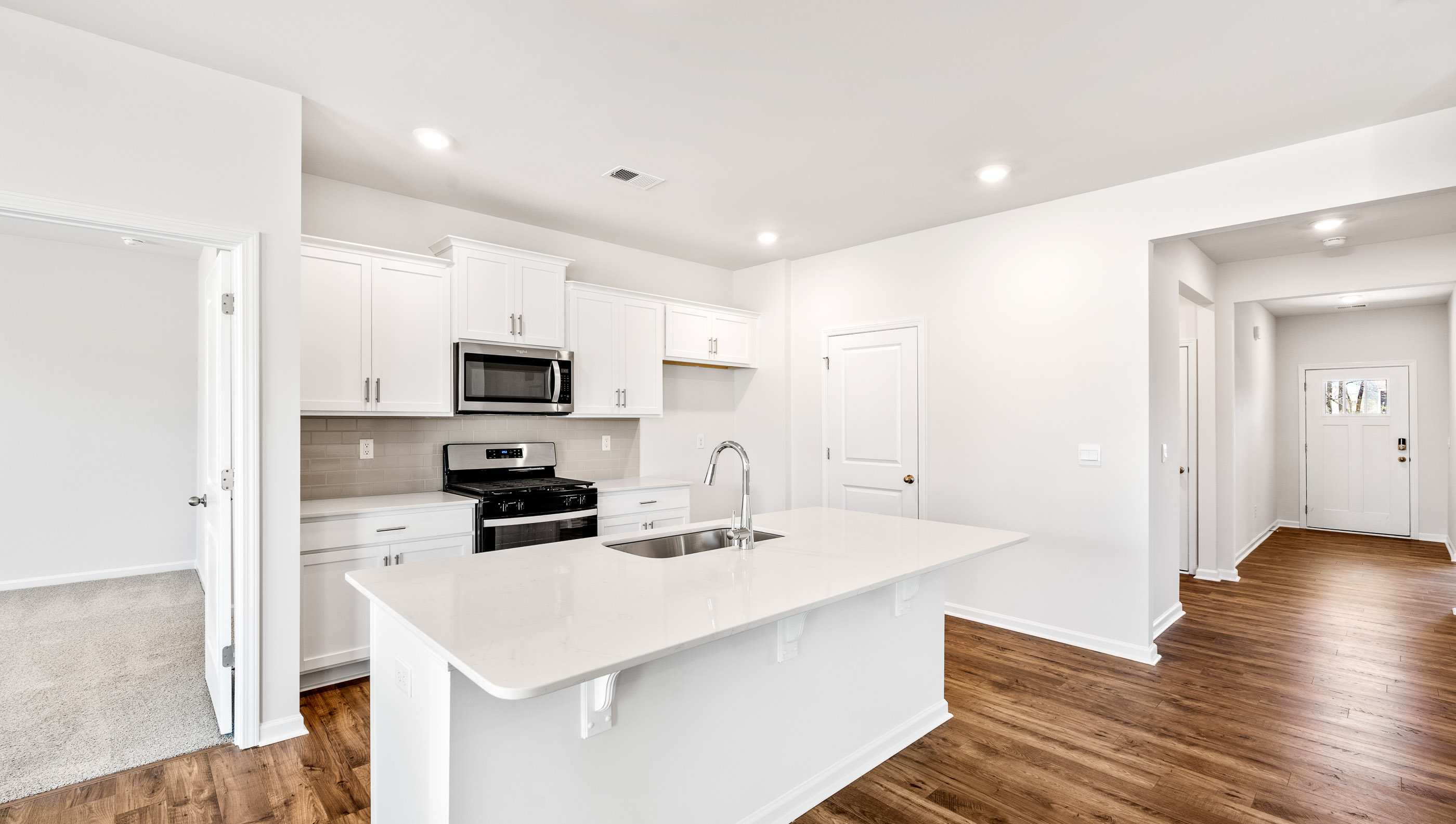 Kitchen with island and cabinets.