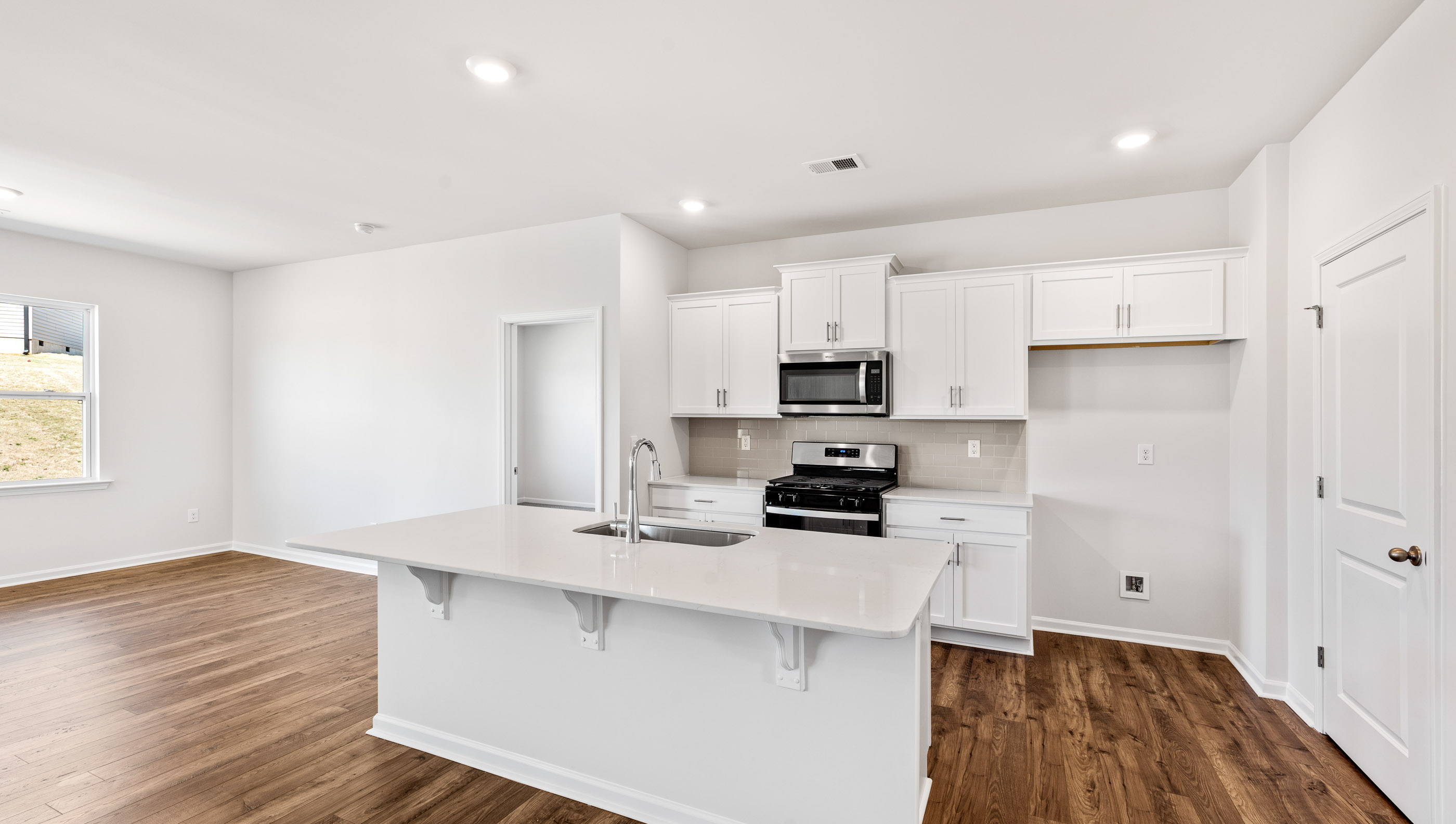 Kitchen with island and cabinets.