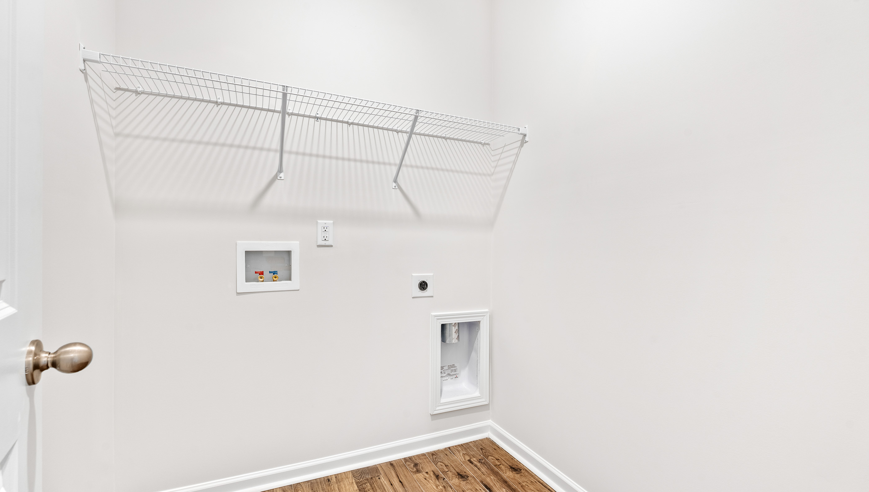 Laundry room with shelf.