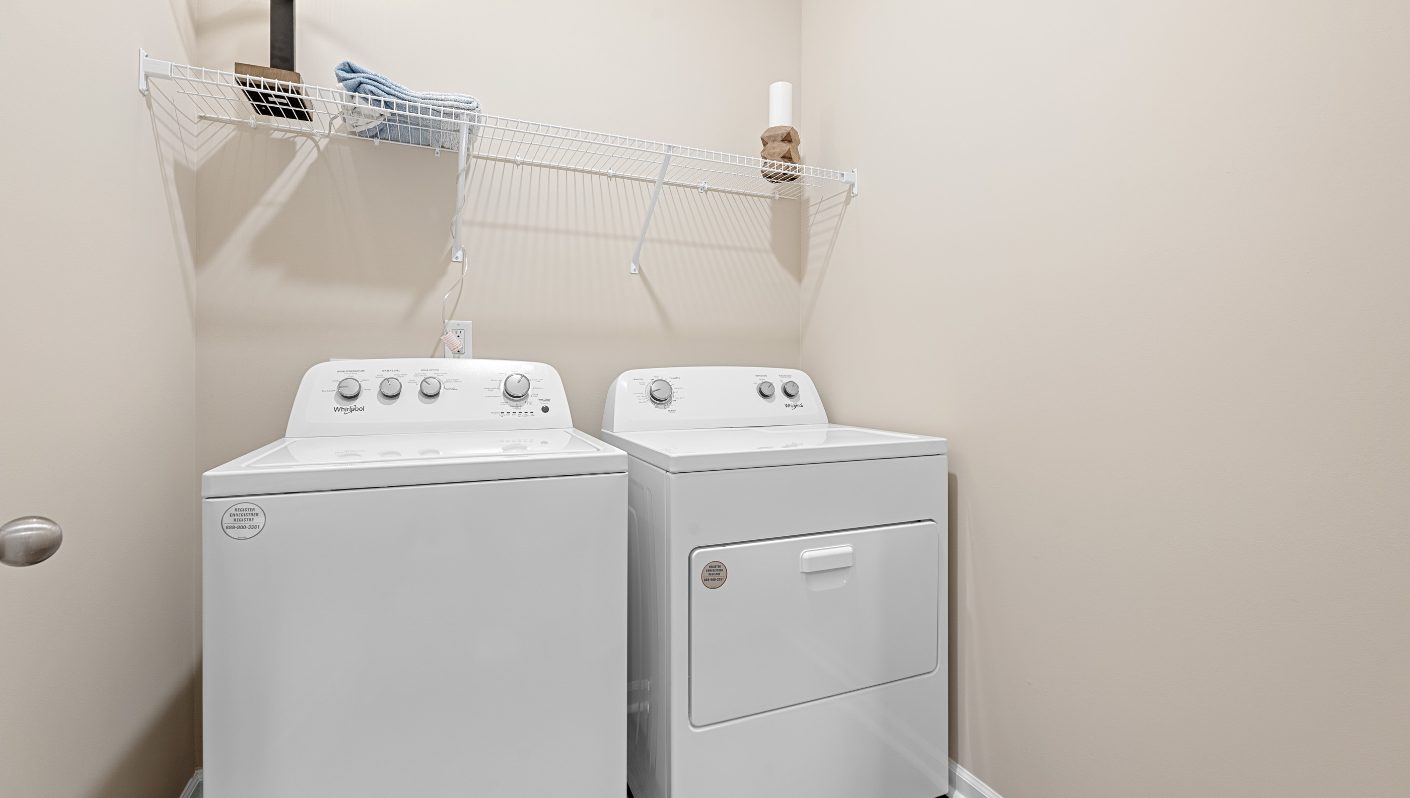 Laundry room with hanging storage racks.