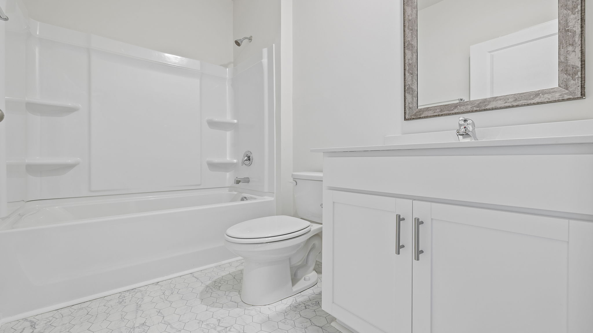 Hall bathroom with vanity and combination shower / tub.