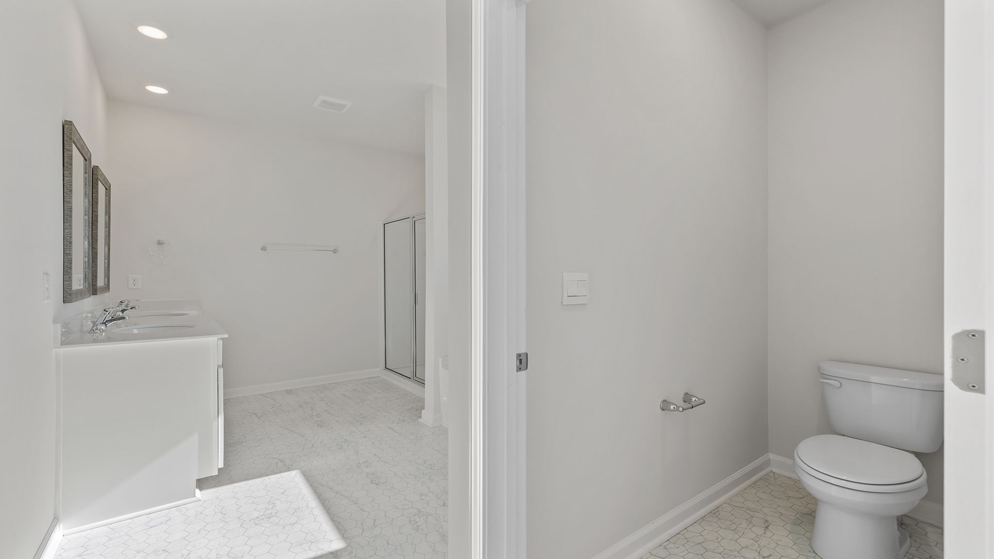 Primary bathroom with dual sink vanity.