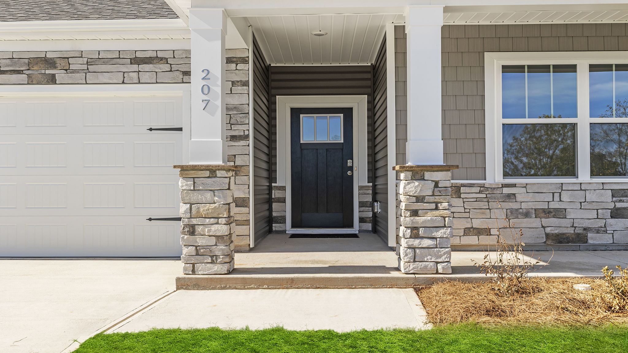 Stone accents and inviting front porch.