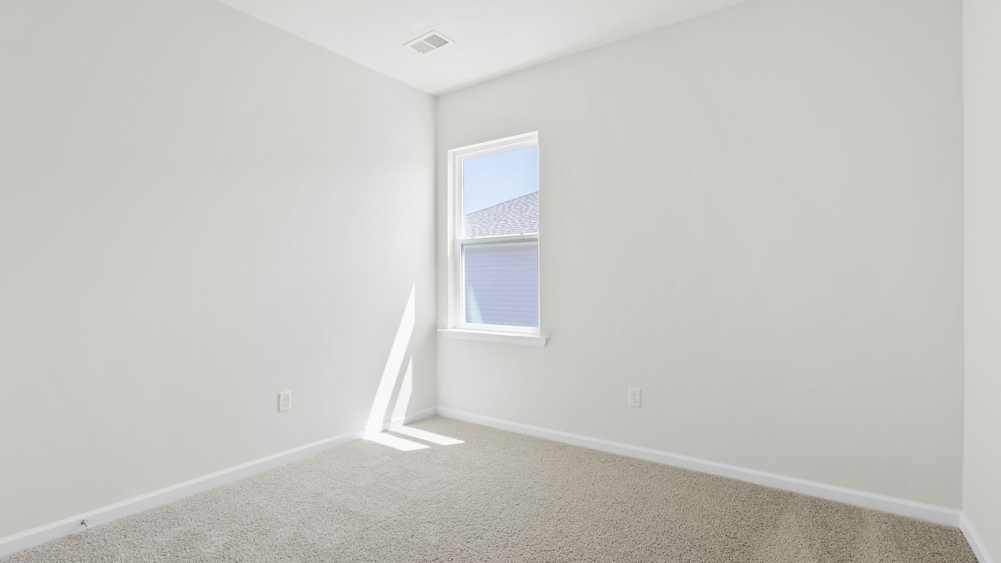 Bedroom with carpet and window.
