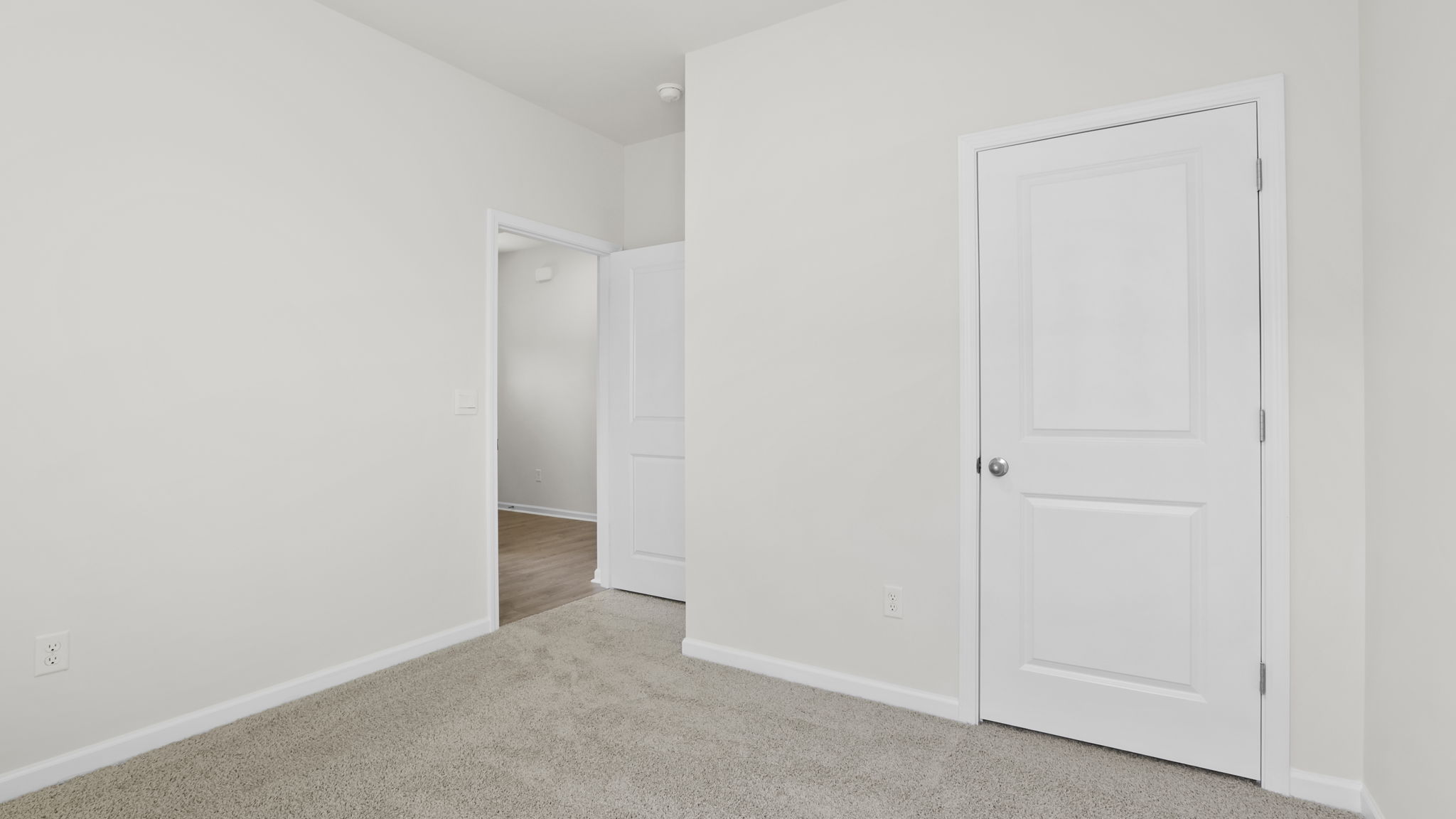 Bedroom with carpet and window.