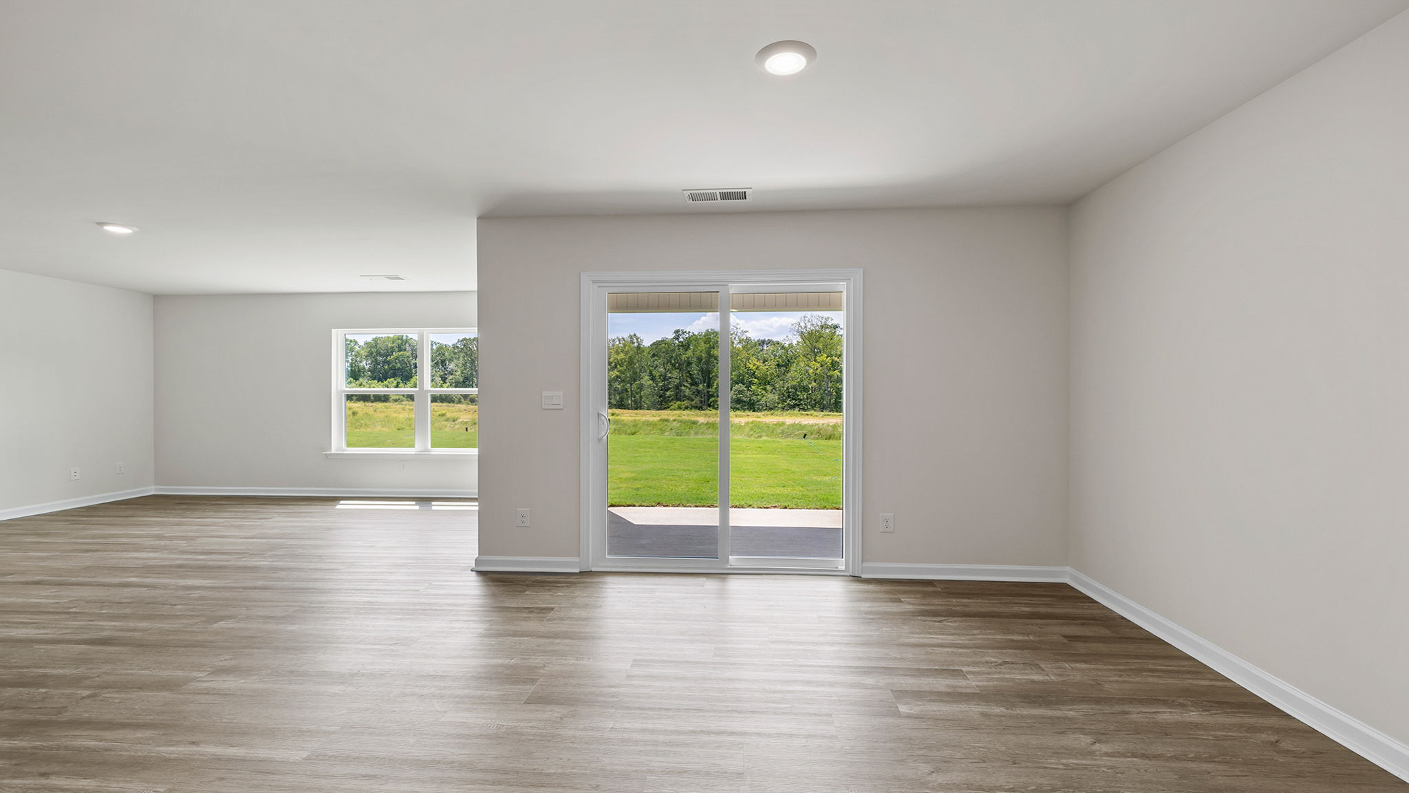 View from kitchen of the dining area and doors to the covered patio. .