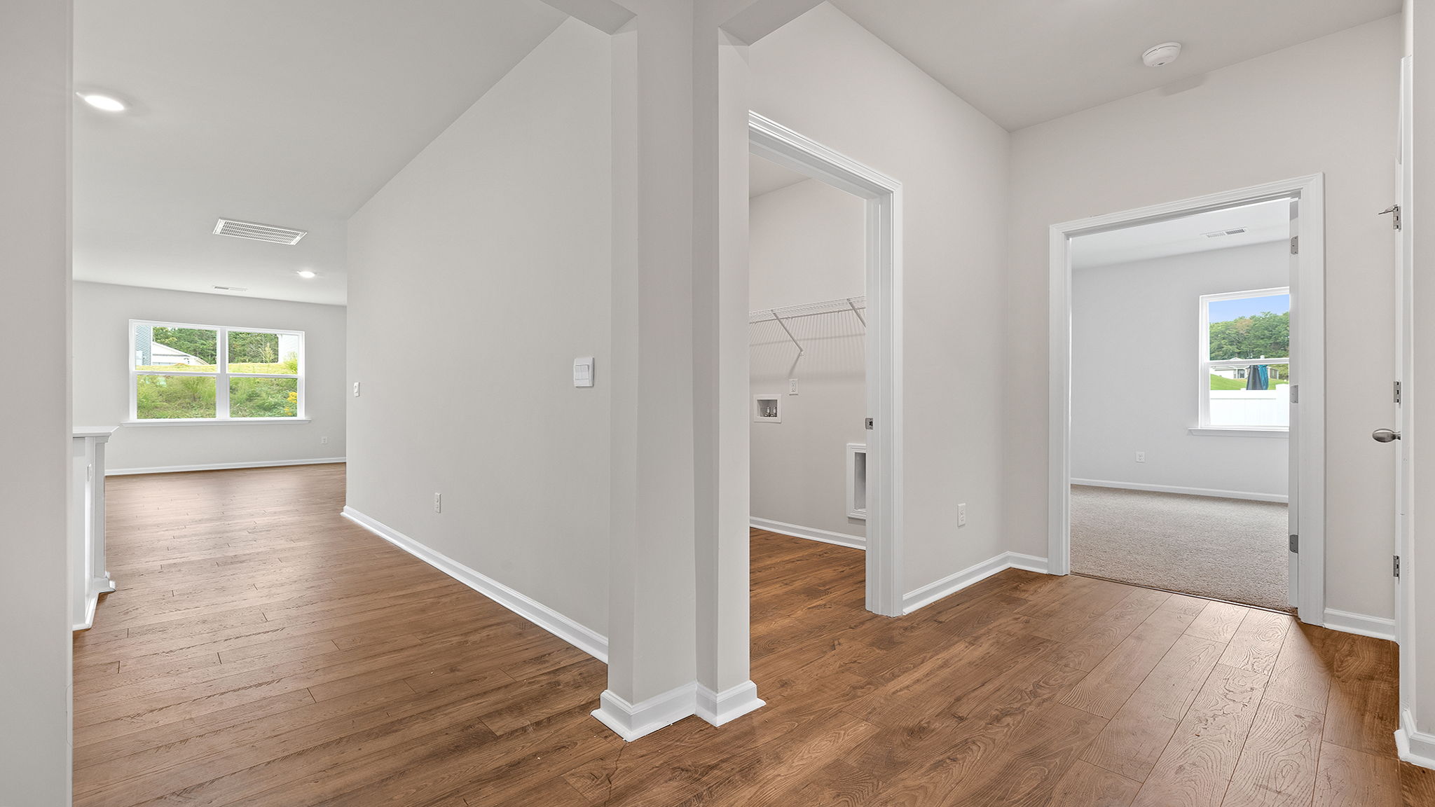 View of third bedroom and laundry room from hallway.