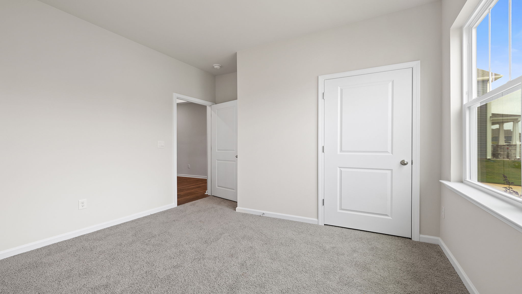 Bedroom with window and carpet.