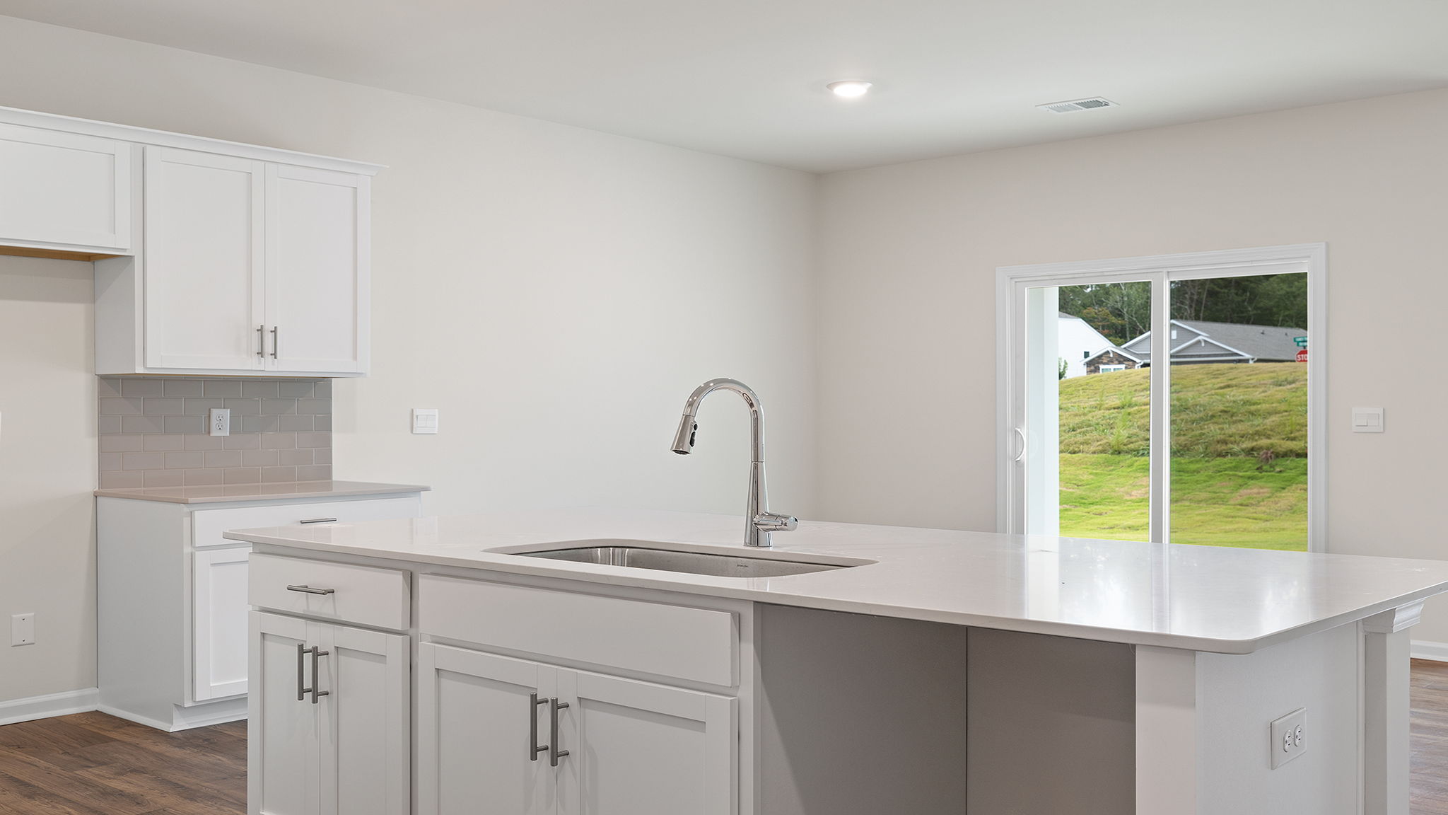 Kitchen island hosts the sink and dishwasher.