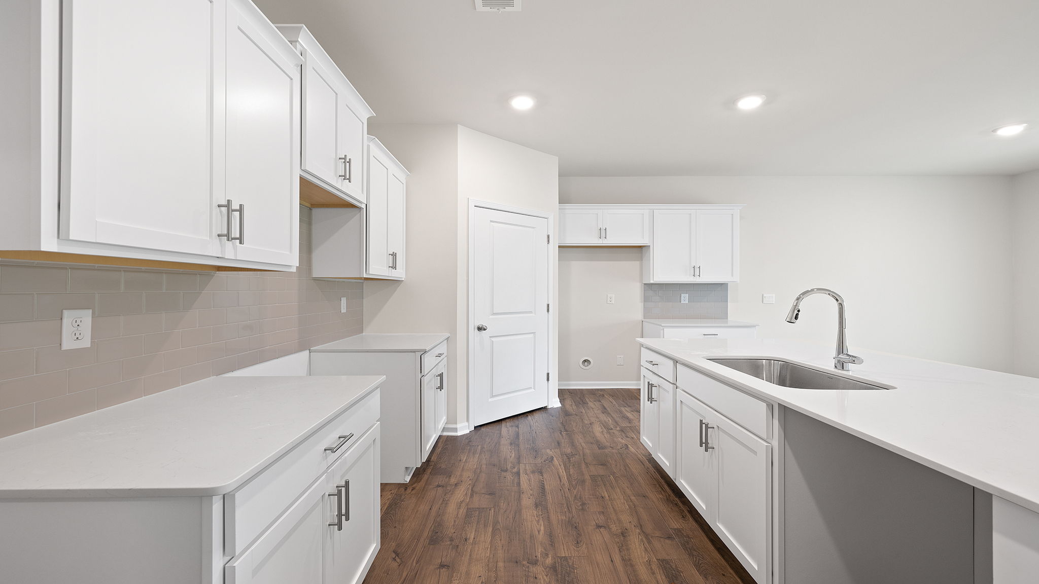 Kitchen and island have quartz countertops.