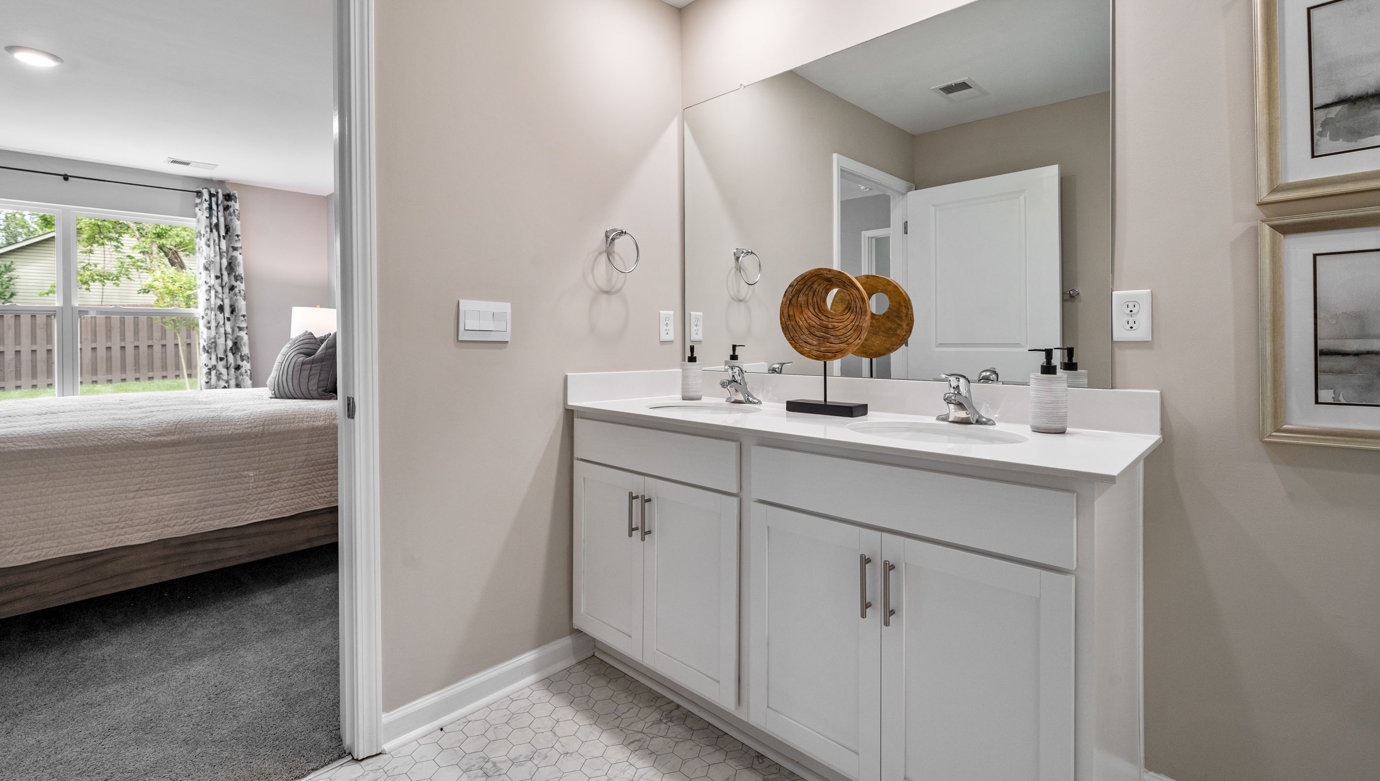 Bathroom with double vanity sink and shower.