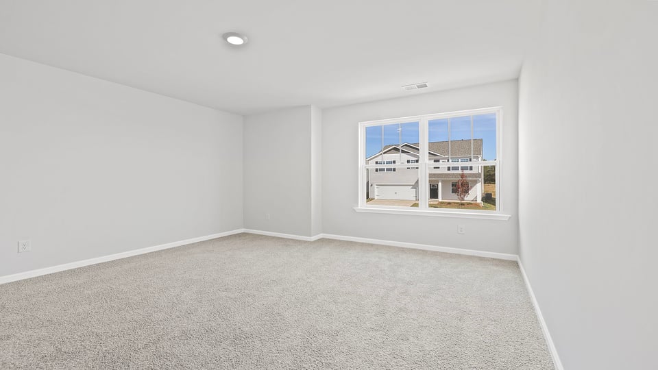 Bedroom with window and carpet.