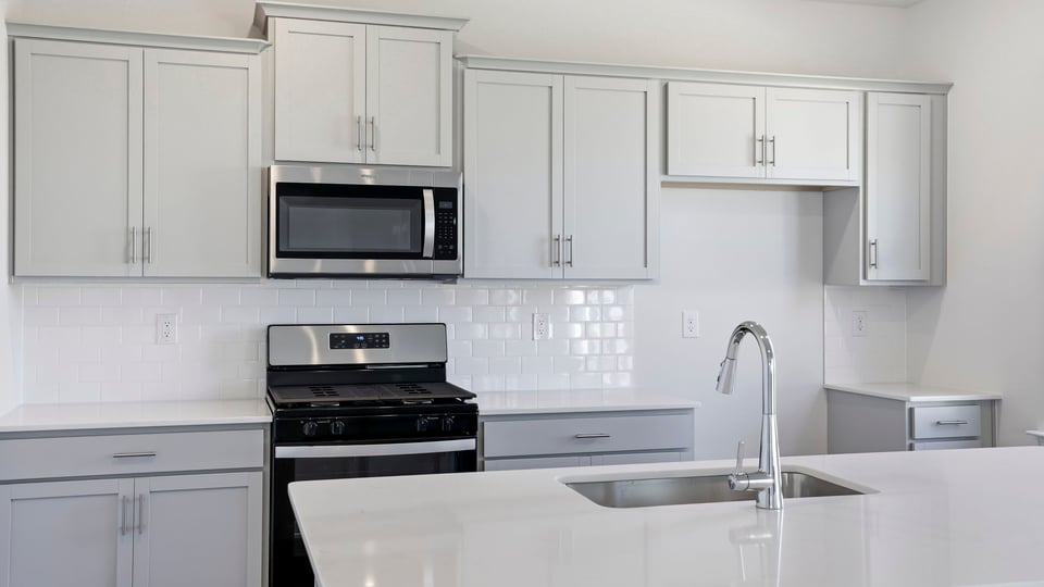Kitchen and island with quartz countertops.