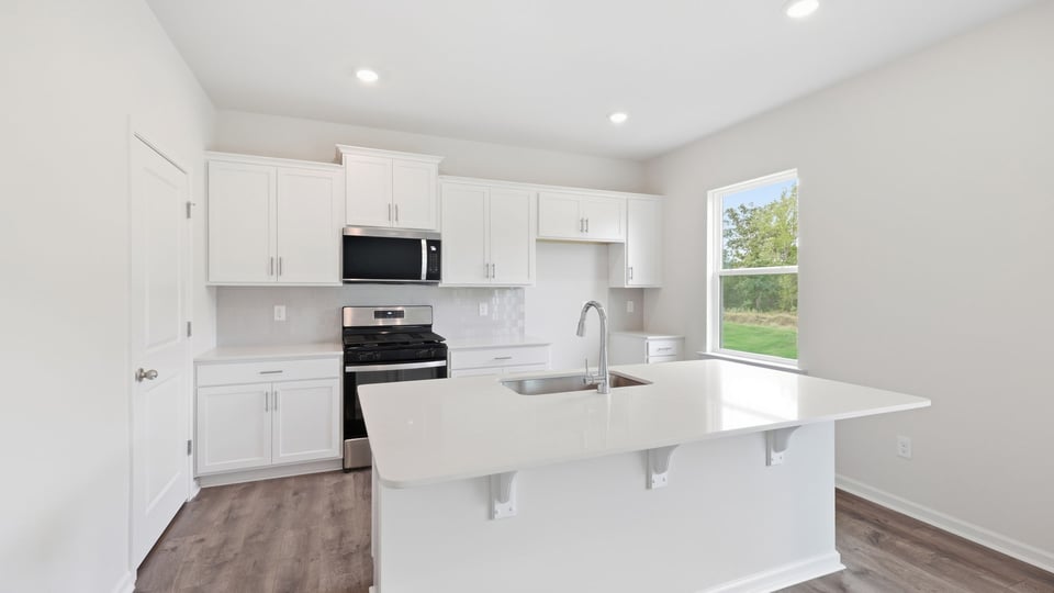 Kitchen with island and cabinets.