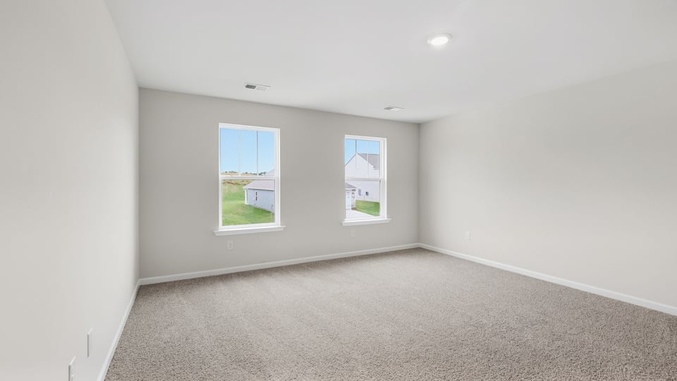 Bedroom with carpet and windows.