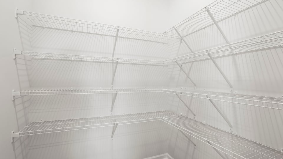 Primary closet with shelf.