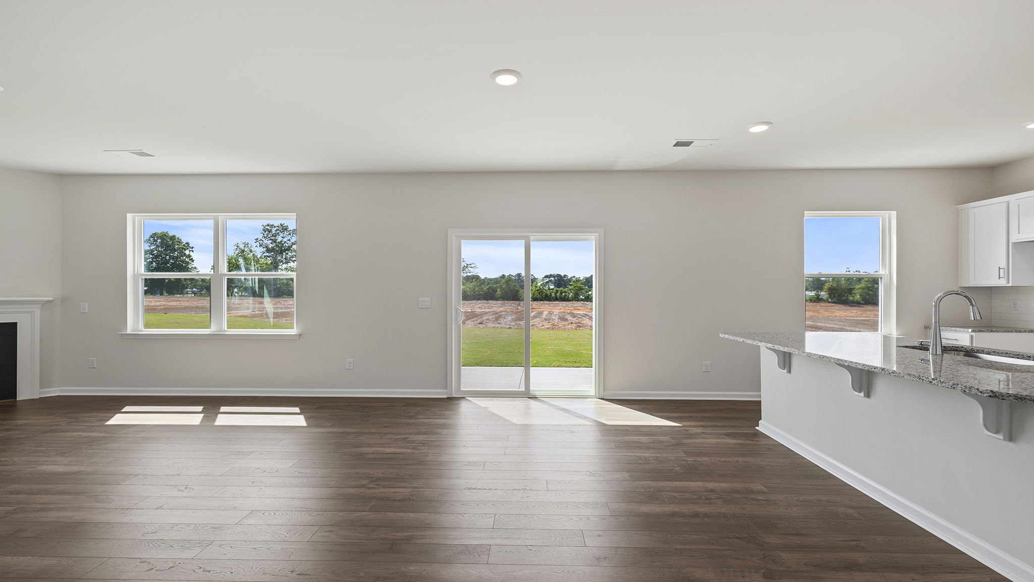View of open floor plan and wall of windows.
