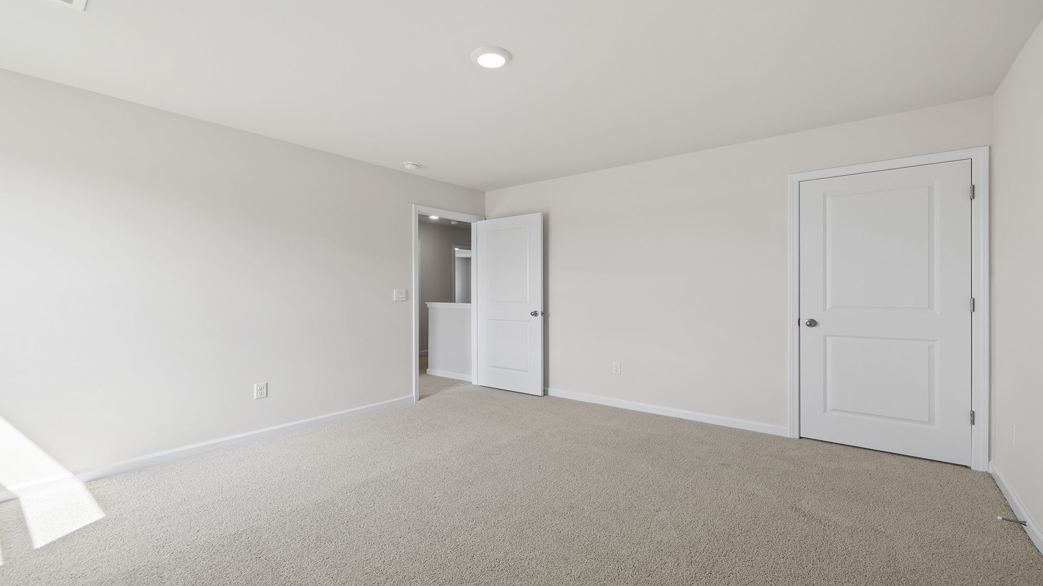 Bedroom with carpet and window.