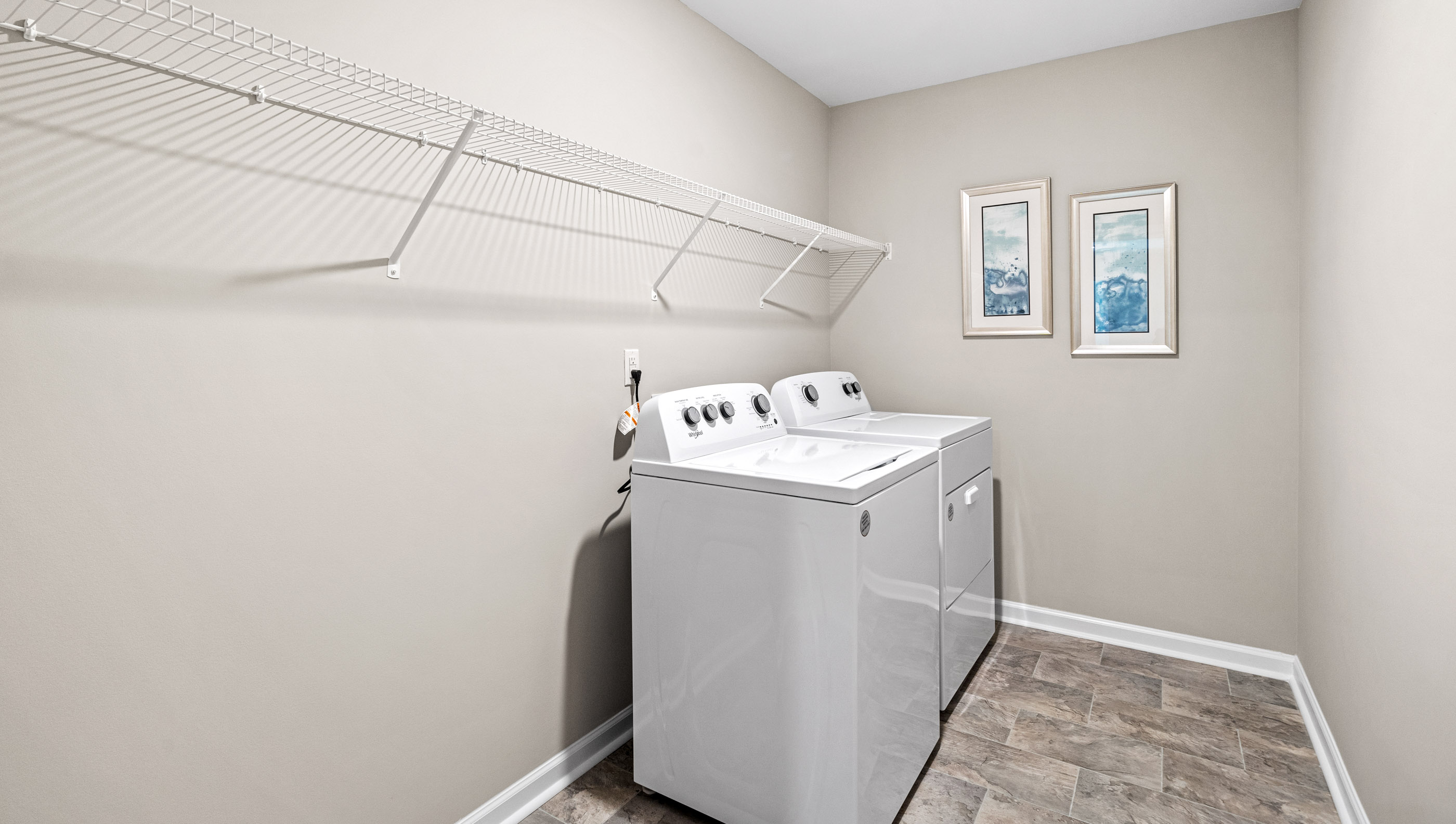 Laundry room with hanging storage racks.