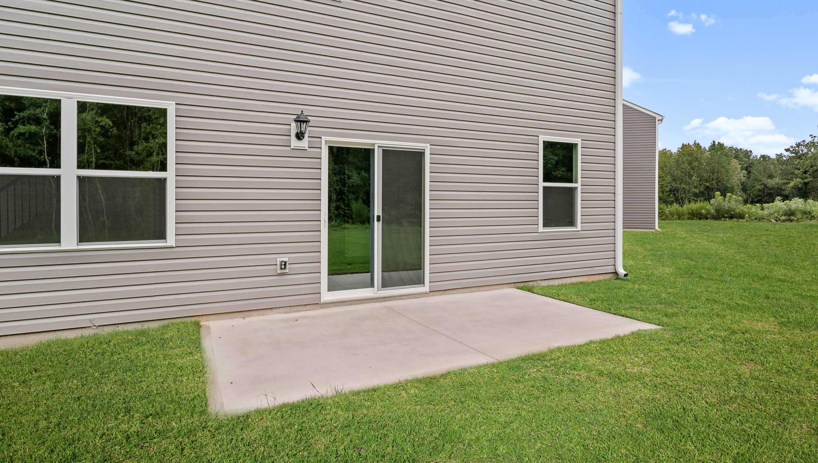 Back exterior of home with large backyard.