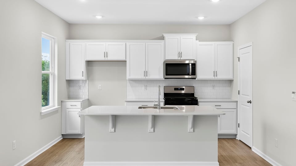 Kitchen and island with quartz countertops.