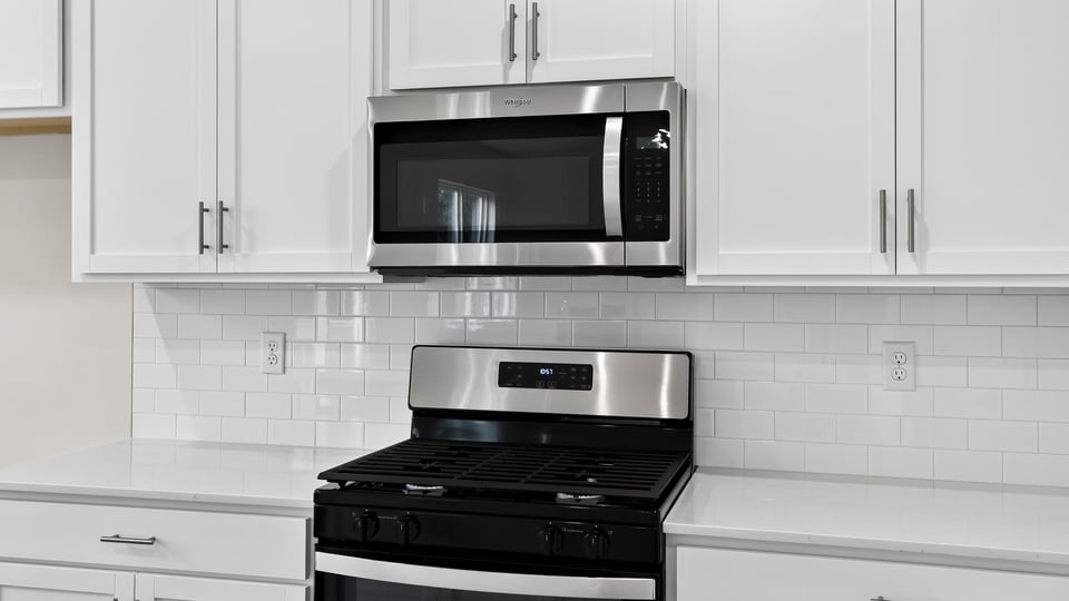 Kitchen and island with quartz countertops.