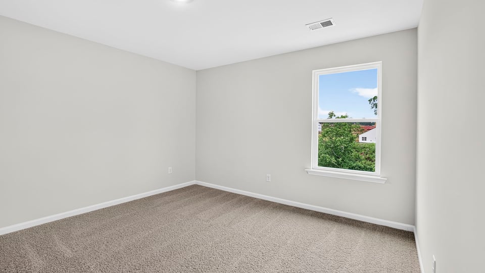 Bedroom with carpet and windows.