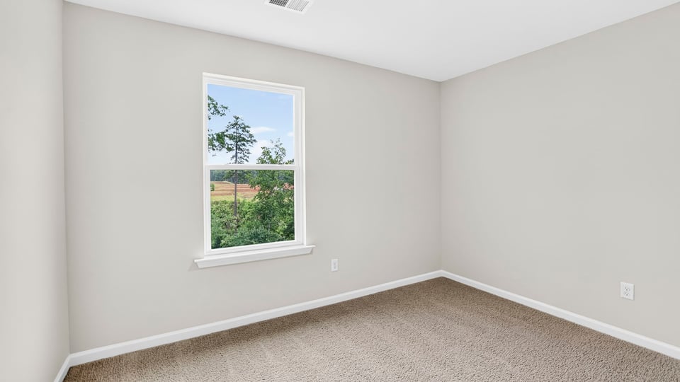 Bedroom with carpet and windows.
