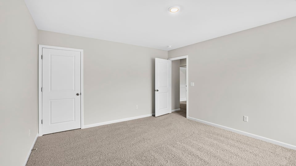 Bedroom with carpet and window.