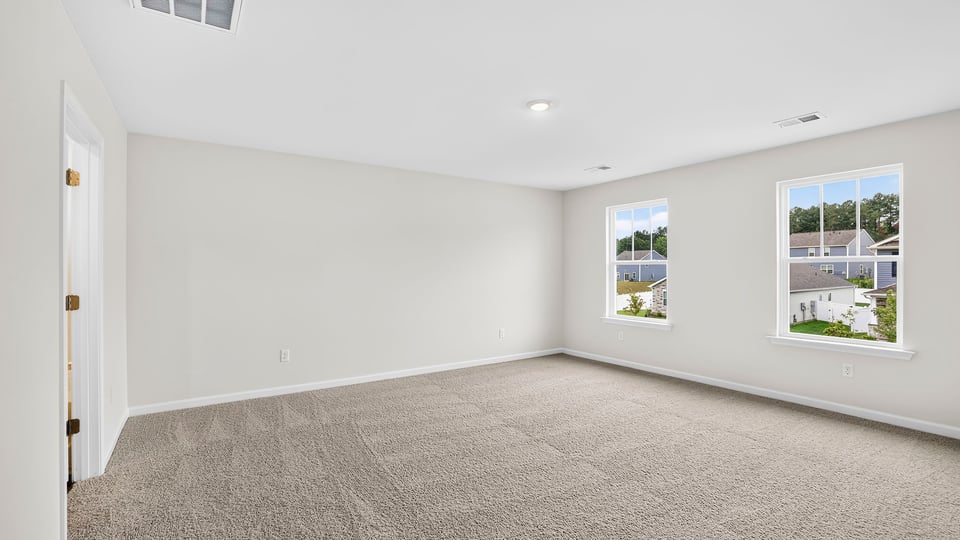Bedroom with carpet and window.