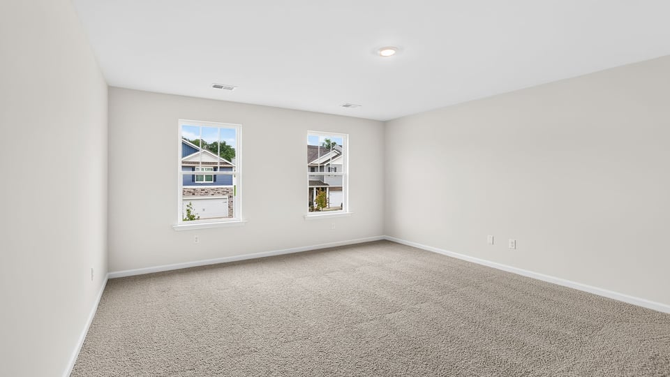 Bedroom with carpet and window.