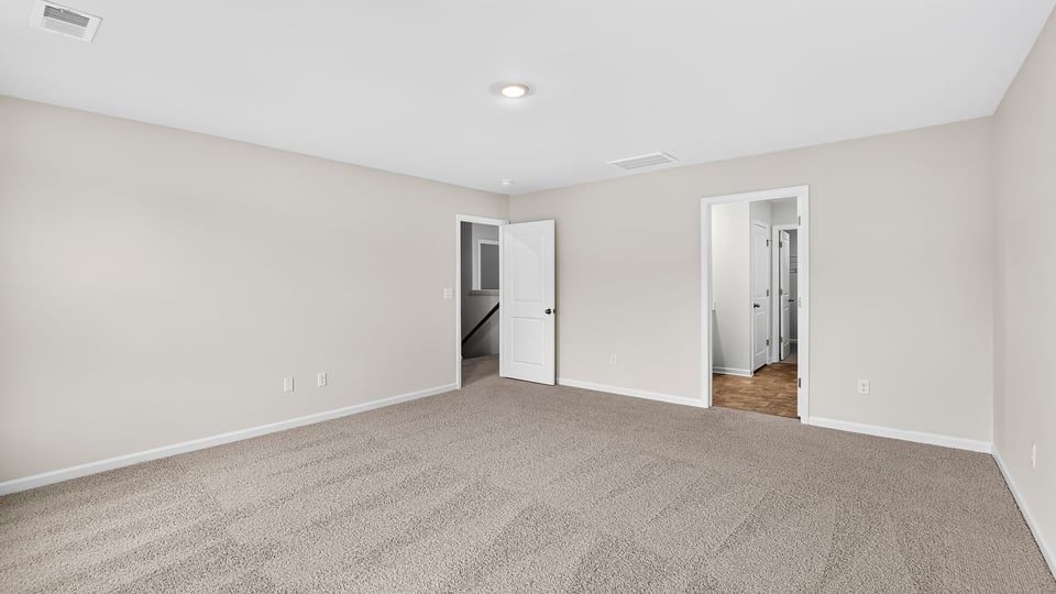 Bedroom with carpet and window.