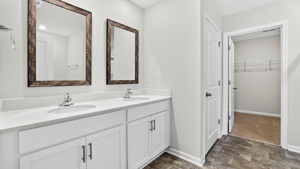 Bathroom with double vanity sink and closet.