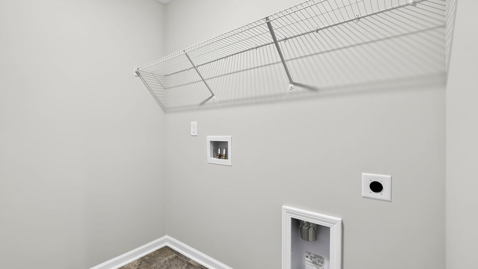 Laundry room with hanging storage racks.