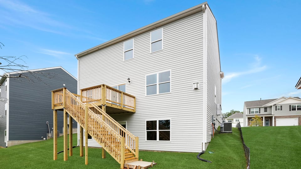 Back exterior of home with large backyard.