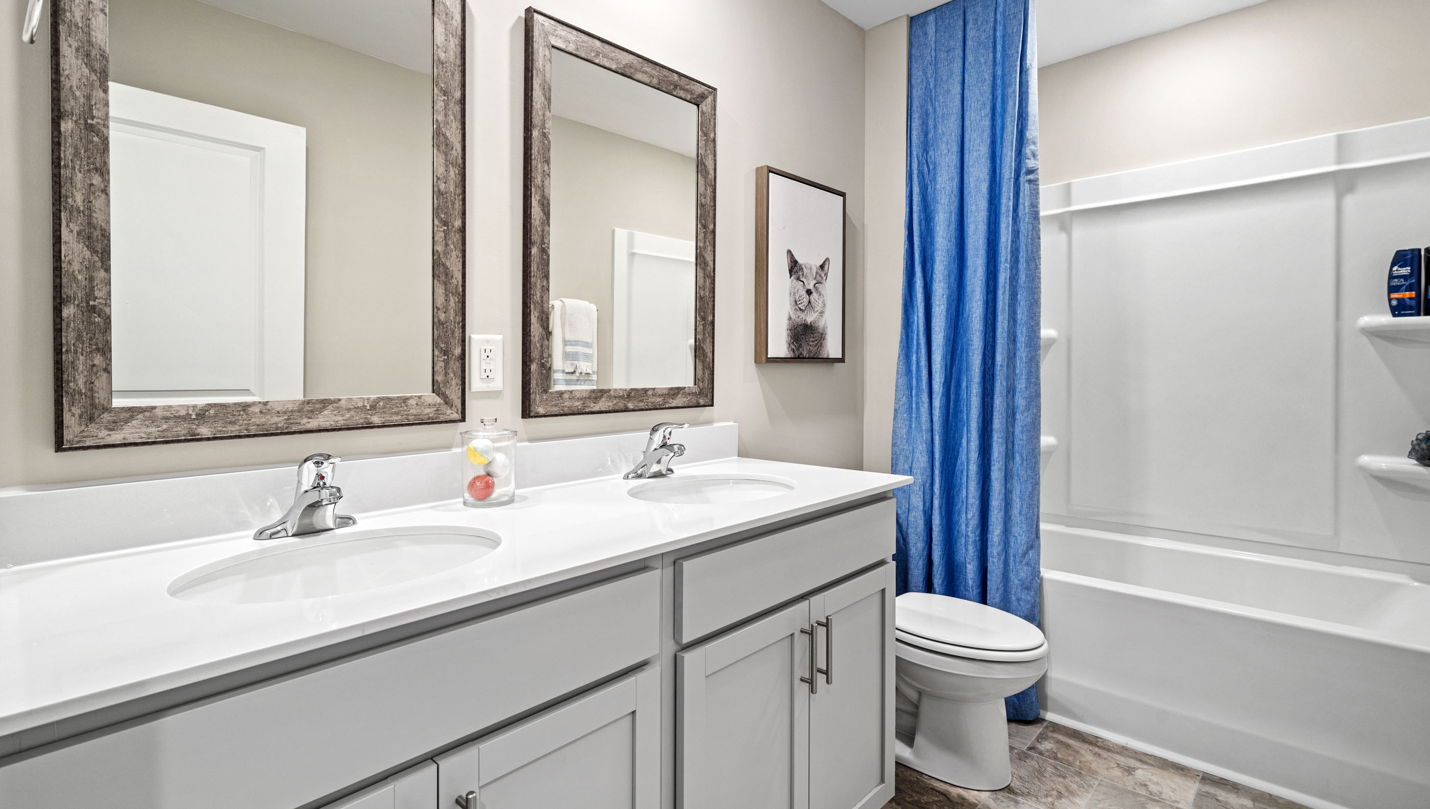 Bathroom with double vanity sink and tub.