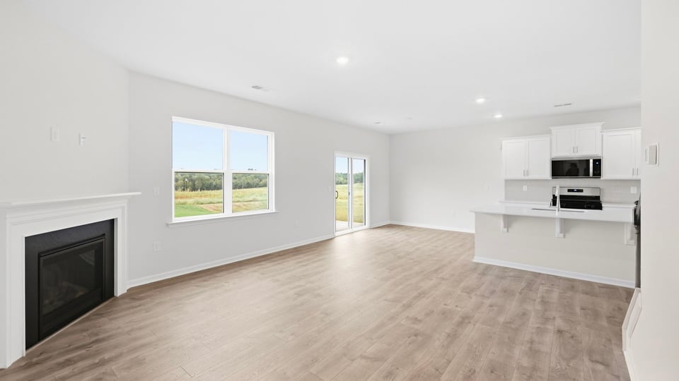 Living area with fireplace and windows.