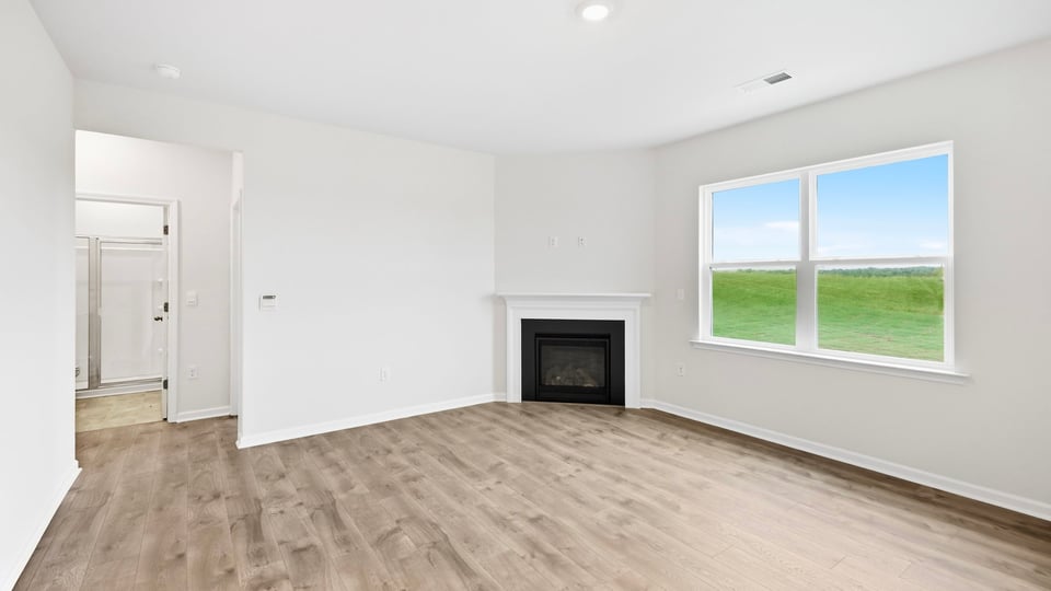 Living area with fireplace and windows.